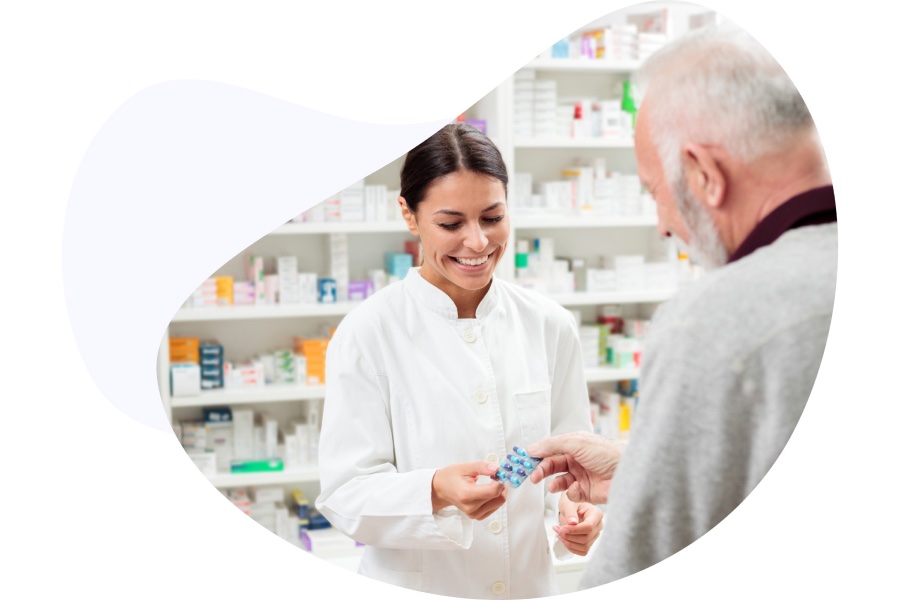 Pharmacy staff giving medication to a man in-store